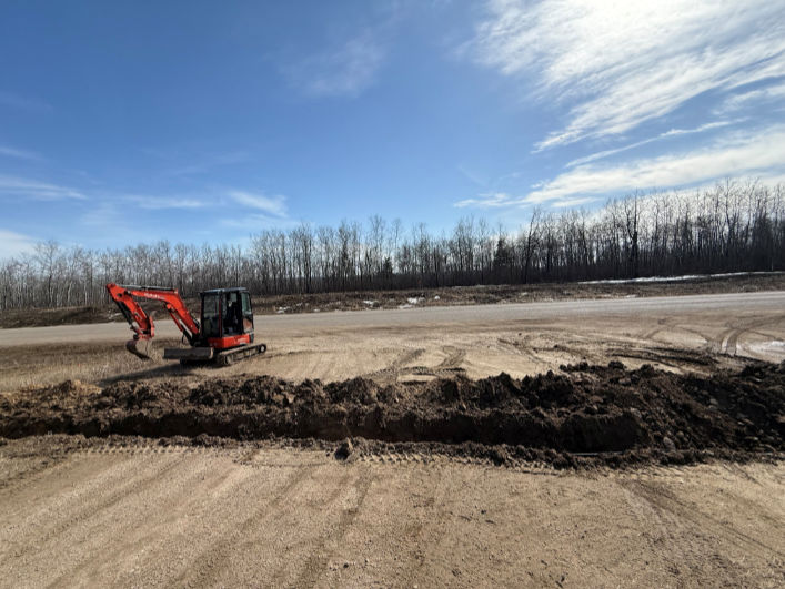 Bergen Brothers Daylighting excavating and trenching on a rural worksite for underground utility preparation.